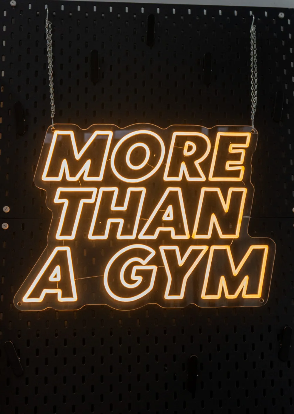 Insegna luminosa More than a gym nella palestra Elevate